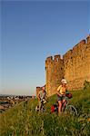 Biker in front of the Castle of Carcassone, Midi, France MR