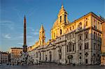 General view at sunrise of Piazza Navona, Sant' Agnese in Agone and the Fountain of the Four Rivers looking south.