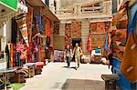 Young couple with Moroccan rugs in Essaouira. Morocco (MR)