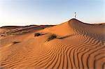 Oman, Wahiba Sands. Man with omani dress on the sand dunes at sunrise (MR)