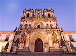 Portugal, Estremadura, Alcobaca, Facade of Santa Maria de Alcobaca Monastery at dusk (UNESCO World Heritage) (MR)
