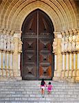 Portugal, Alentejo, Evora, Evora cathedral, girls walking up steps   (MR)