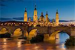 Basilica de Nuestra Senora del Pilar church and Ebro river at dusk, Zaragoza, Aragon, Spain