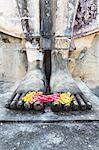 Thailand, Sukhothai Historical Park. Detail of Buddha feet with floreal offering