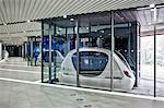 A personal Rapid Transit pod parked in the Masdar PRT station of the Masdar Institute of Science and Technology, Masdar City, Abu Dhabi, United Arab Emirates.