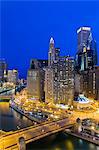 USA, Illinois, Chicago. Night time view over the city showing the river dyed green for the St Patrick's Day Celebrations.