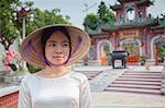 Woman wearing Ao Dai dress at Phouc Kien Assembly Hall, Hoi An (UNESCO World Heritage Site), Quang Ham, Vietnam (MR)