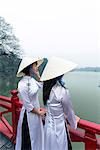 Vietnam, Hanoi, Hoan Kiem lake. Young vietnamese girls in traditional Ao Dai dress (MR)