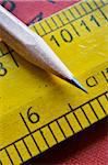 Close-up of sharpened pencil and wooden ruler