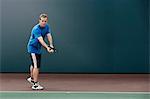 Tennis player about to serve ball in tennis court