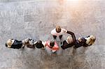 Overhead view of business team congratulating colleague