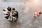 Overhead view of business team in circle with hands together