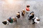 Overhead view of business team watching and listening in office