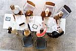 Overhead view of business team meeting clients at desk in office