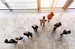 Overhead view of business team looking out of office window