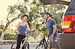 Mature cyclist couple chatting in park