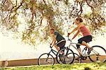 Mature couple cycling in park