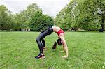 Full length side view of fit woman exercising in park
