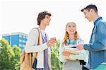 Happy university students conversing at campus