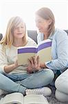 Mother assisting daughter in homework at home