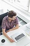 High angle view of businessman working at desk in creative office