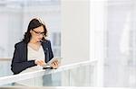 Young businesswoman using tablet PC in office