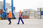 Full-length of workers walking in shipping yard