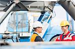 Workers shaking hands in shipping yard