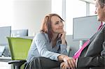 Loving business couple looking at each other in office