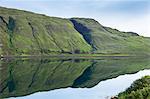 Mountain slopes reflected in the waters of a loch, Isle of Skye, Inner Hebrides, Highlands and Islands, Scotland, United Kingdom, Europe