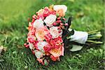 Beautiful Bridal bouquet of various flowers on grass.