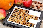 diet, sleep, exercise and mindset - vitality concept - abstract in vintage letterpress wood type on a digital tablet with apples, pumpkin and hazelnuts
