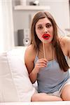 a girl joking with false carton red lips