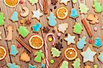 Christmas closeup wooden background with candies, spices, gingerbread cookies