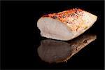 Delicious juicy chicken breast steak isolated on black background. Culinary meat eating.