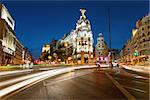 Crossing Alcala and Gran Via street in Madrid by night