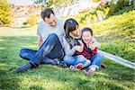 Happy Mixed Race Family Having Fun Outside on the Grass.