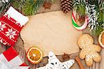 Christmas food and decor with snow fir tree background with paper for copy space