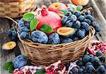 Fresh autumn fruits - pomegranate, plums, grapes and apples