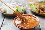 Hot and spicy Asian dish. Yummy chicken sate or satay, skewered and grilled meat, served with peanut sauce. Fresh cooked with steamed and smoke.