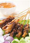 Chicken sate or satay, skewered and grilled meat, served with peanut sauce. Fresh cooked with steamed and smoke. Delicious hot and spicy Asian dish.