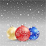 The multicolored christmas bauble and snow on the gray background