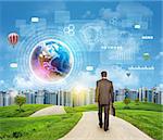 Businessman walks on road. Rear view. Buildings, grass field and sky with Earht and other virtual elements. Elements of this image furnished by NASA