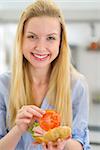 Smiling young woman making sandwich