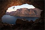 Female rock climber on a cliff in a cave at Kalymnos, Greece