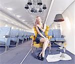 Beatiful woman in the luxury armchair in an airplane cabin. 3d creativity concept