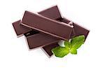 Delicious dark brown chocolate bar with mint leaves isolated on white background. Culinary dessert eating.