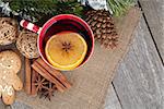 Christmas mulled wine with fir tree, gingerbread and spices on wooden table