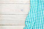 Blue towel over wooden kitchen table. View from above with copy space