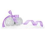 Christmas baubles and purple ribbon over snow. Isolated on white background with copy space